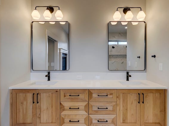 Modern bathroom vanity with double sinks, wooden cabinetry, dual mirrors with black frames and sconce lighting above